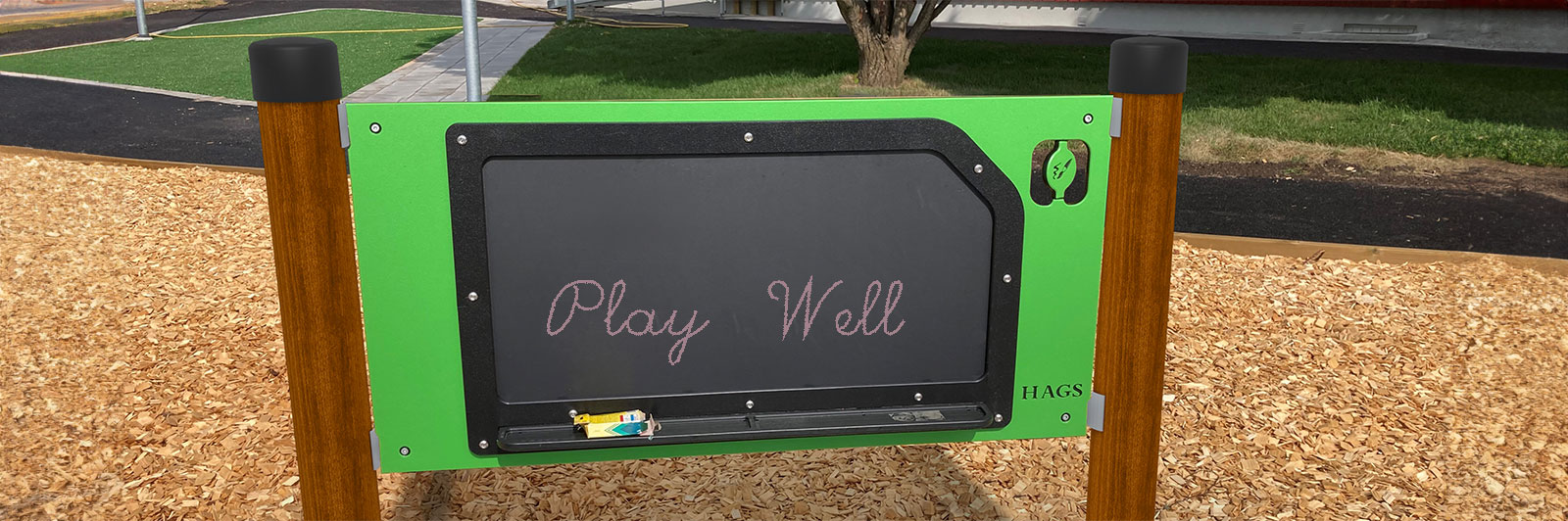 A chalkboard play panel, with play well written on it in chalk.